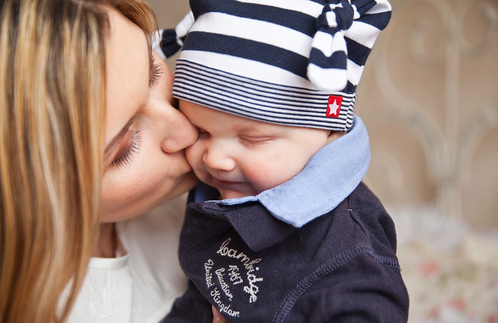 Mom kissing baby boy