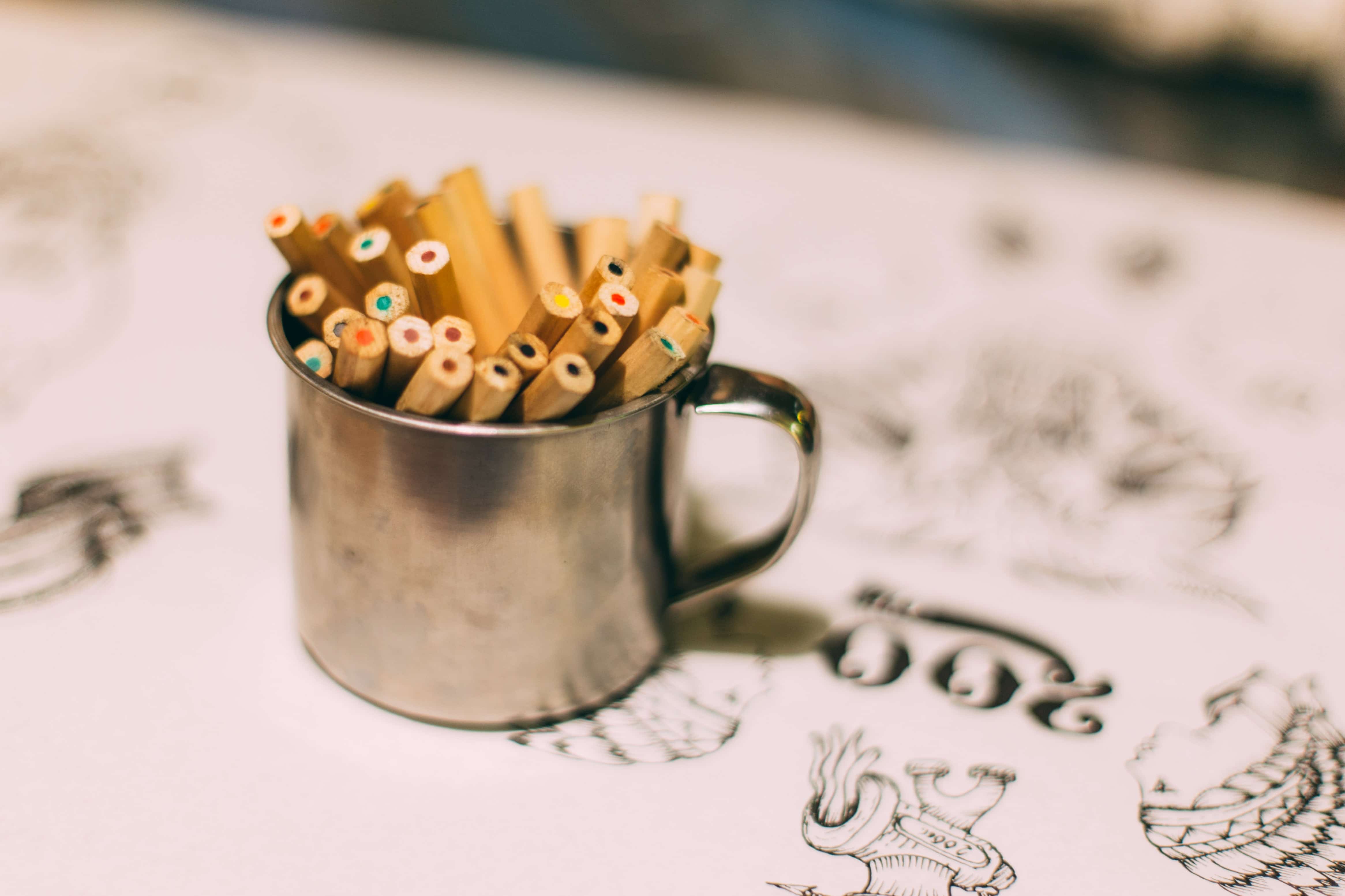 colored pencils in a silver cup