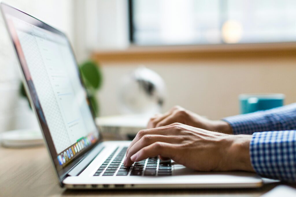 man typing on a computer